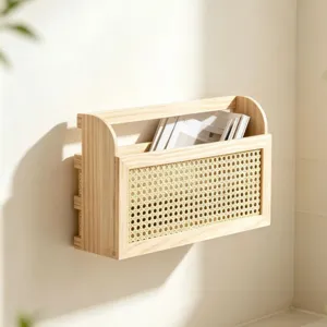 Dettaglio del portariviste da parete in legno e rattan, organizer per documenti e libri da casa.