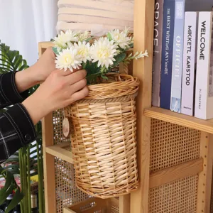 Wicker wall-mounted storage basket detail, natural woven hanging flower basket for home decor.