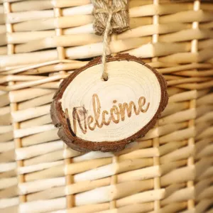 Handmade wicker wall hanging basket detail showing natural woven texture and welcome tag.