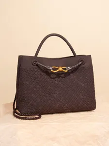 Dark brown woven leather tote bag with metal knot handle and shoulder strap front view