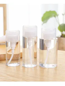Clear travel pump bottle detail view, portable cosmetic sub-bottling dispenser container.
