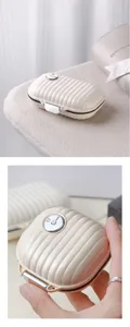 Portable mini jewelry storage box, compartment pill case with secure lock and chic ribbed design.