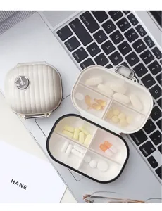 Portable mini suitcase storage box with multiple compartments for pills, rings, and jewelry items.