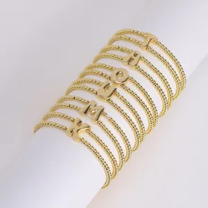 Gold plated brass beaded stretch bracelets featuring cute chubby puffed letter charms set.