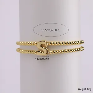 Gold-plated double strand beaded bracelet detail view, elegant letter S pendant charm closeup.
