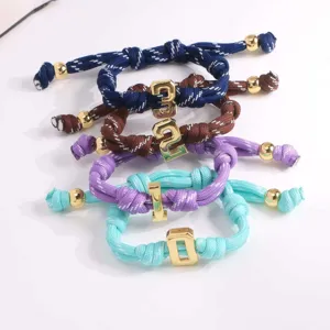 Woven rope bracelet set with 3D number charms and gold beads, colorful braided cord jewelry.