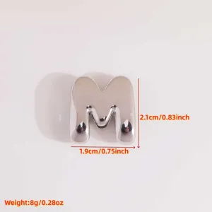 Detail view of the 3D letter M pendant, featuring a smooth metallic finish and compact size.