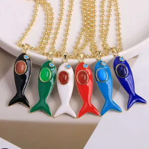 Detailed view of colorful enamel fish pendant necklaces featuring center gemstone inlays.