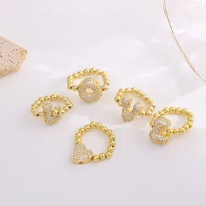 Detailed view of fashion copper micro-paved cubic zirconia letter and heart rings, 18k gold plated.