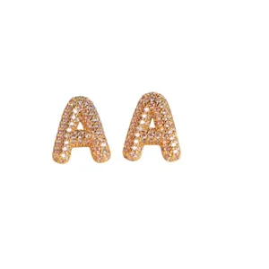 Gold-tone letter A stud earrings paved with sparkling pink cubic zirconia for women and men.