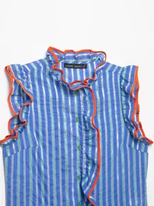 Blue striped sleeveless shirt detail, orange ruffle trim and green buttons close-up view.