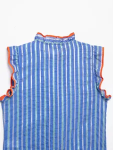 Detailed view of women's blue striped sleeveless shirt featuring vibrant orange ruffle trim.