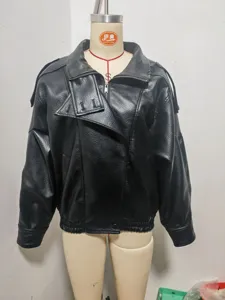 Close-up detail of the black litchi grain faux leather jacket showing stylish double collar and zipper.