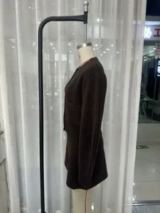 Brown knitted two-piece set featuring a round neck cardigan and high-waist skirt.