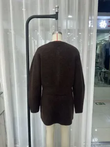 Brown knit two-piece set featuring a crewneck top and high-waist mini skirt.