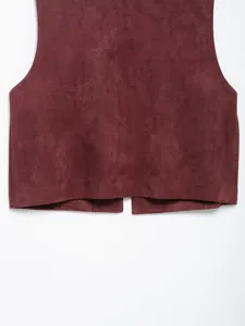 Close-up detail view of the burgundy faux suede vest showing soft fabric texture.
