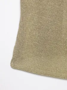 Close-up detail of shimmering gold metallic knit fabric, showing delicate texture and weave.