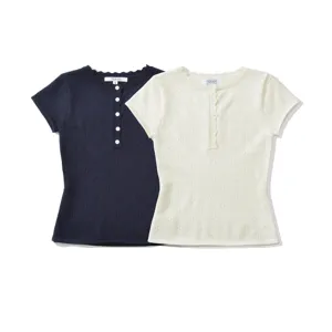 Detailed view of short sleeve knit top with button placket and delicate hollow out pattern.