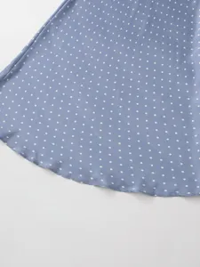 Blue silk satin polka dot skirt fabric detail showing elegant white dots and smooth hem.