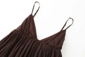 Detailed view of the dark brown camisole top featuring a chic V-neck and delicate ruffled hem.
