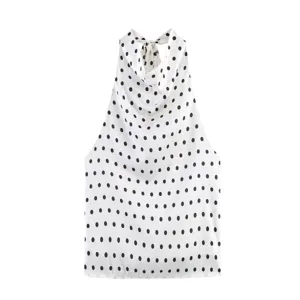 Detalle del top halter con lunares, elegante cuello drapeado y diseño sin mangas chic.