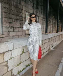 Elegant polka dot jumpsuit set featuring long sleeves and a stylish waist belt for women.