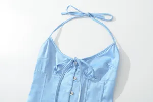 Detailopname van een lichtblauwe satijnen haltercorsettop met verstelbare bandjes en strik.