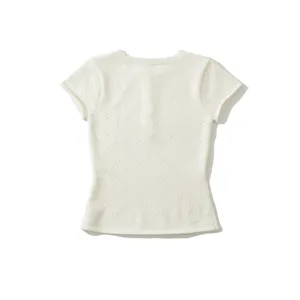 Detailed view of the summer breathable pointelle knitted short-sleeve top texture.