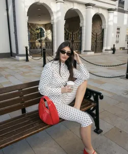 Elegant European style black and white polka dot two-piece set, stylish blouse and pants.