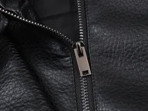 Close-up detail of black faux leather jacket zipper, premium lychee texture and metal hardware.