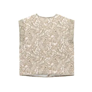Vintage floral quilted vest detail, showing intricate retro print and soft fabric texture.