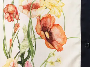 Close-up view of the vintage floral print fabric with red and yellow flowers on beige.