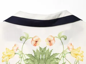 Detailed view of the vintage floral print shirt collar with contrast trim, elegant design.