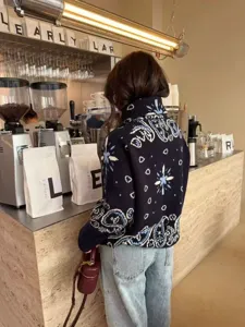 American vintage jacquard knit cardigan, retro paisley and star pattern, detailed back view.