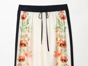 French vintage floral print casual trousers detail view with contrast side stripes and drawstring