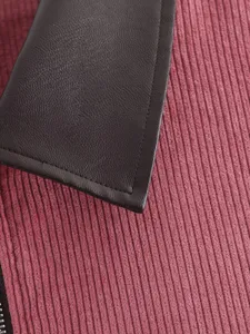 Close-up detail of the pink corduroy jacket featuring a contrast dark brown leather lapel.