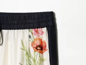 Detailed view of women's vintage floral print casual trousers with black elastic waist.