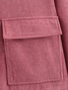 Pink corduroy jacket fabric detail shot, showing textured fabric and front pocket design.