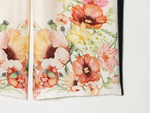 Fabric detail of French vintage floral print casual trousers with colorful flowers and side stripe.