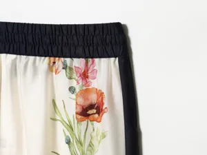 Detailed close-up view of women's French retro floral printed casual trousers with elastic waist