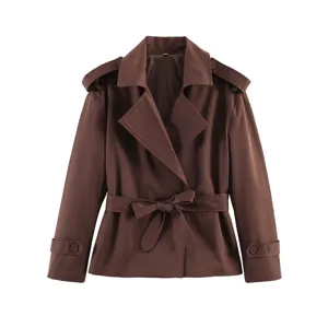 Detail view of the brown short trench coat featuring classic lapels and a chic belt.