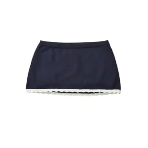 Summer knit mini skirt detail, navy blue with white scalloped hem, breathable fabric.