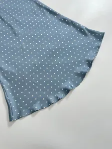 Blue satin polka dot midi skirt detail, elegant high-waist fishtail hem design for women.