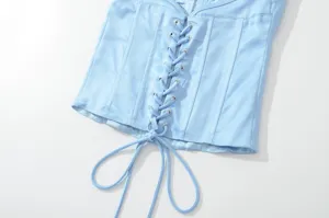 Lichtblauwe satijnen corset top detail met vetersluiting aan de voorkant en baleinen.