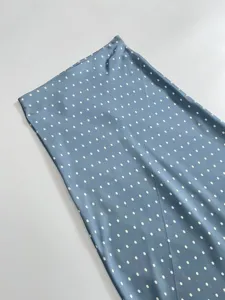 Elegant blue satin midi skirt featuring white polka dots and chic high waist fishtail style.