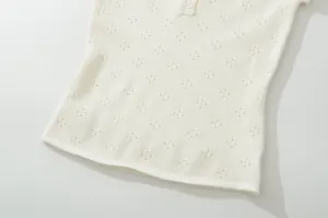 Detailed view of women's summer breathable knit short-sleeve top with buttons and hollow pattern.