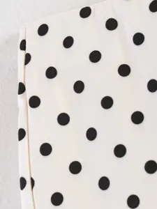 Detailed close-up view of elegant black and white polka dot fabric texture pattern