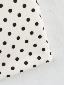 Black and white polka dot fabric detail view showing premium texture and neat stitching.