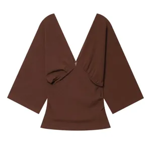 Detailed view of the brown deep V-neck short sleeve top with pleated front design.