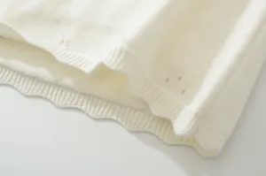 White knit top skirt set detail view, breathable hollow-out design with ribbed hem texture.